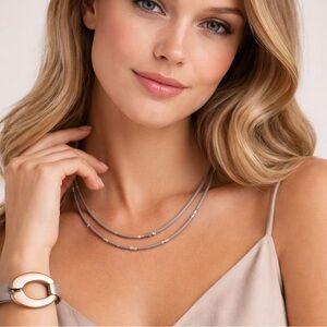 Set Saachi grey leather goldtone loop wrap bracelet and matching necklace.